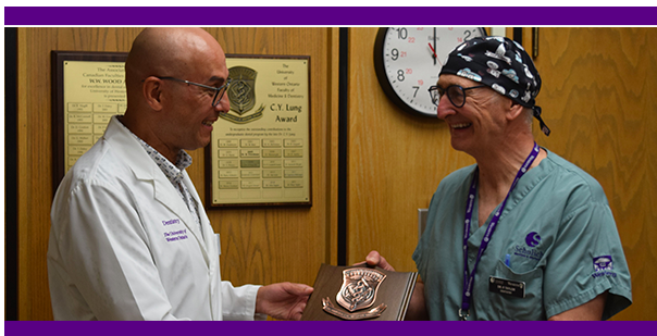 Dr. Taylor received the 2021 C.Y. Lung Award from Dr. Fernando Inocencio.