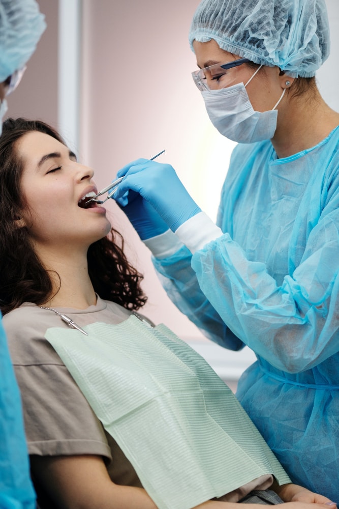 Dentist examining gums | Shore Side Dentistry